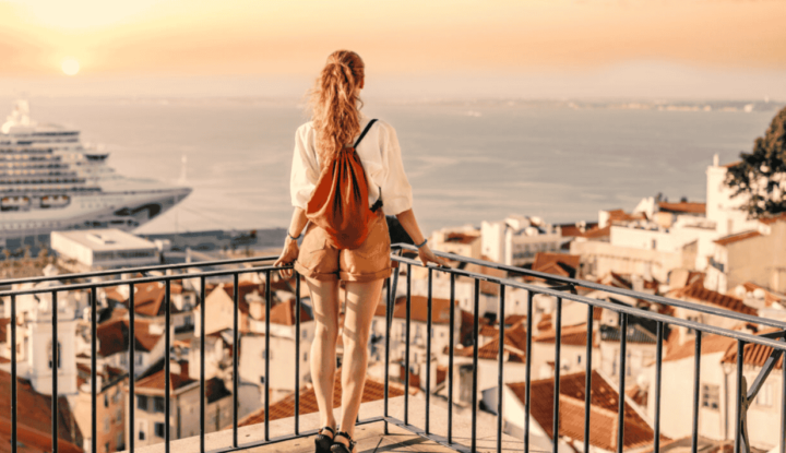 Creative ways hotels are using gift cards in 2025 - A woman stands over a lookout facing the ocean in Europe - Hospitality Solutions