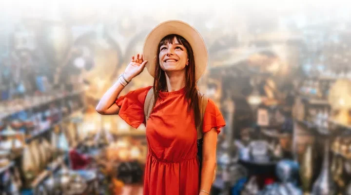 SynXis Retailing - Girl smiles while holding hat - Sabre Hospitality