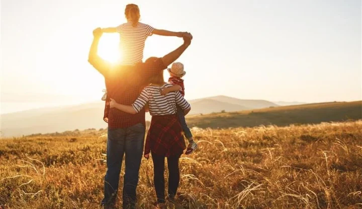 A family stands in a field looking at the sunset. 8 game-changing hospitality trends for 2025 - Sabre Hospitality