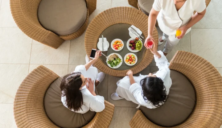 Hospitality software trends shaping the industry in 2025 - Two ladies recieve personal service at a hotel breakfast - Sabre Hospitality