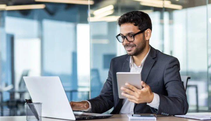 Top 10 Hotel Marketing Strategies for 2025 - Photo of a man on his computer - Sabre Hospitality