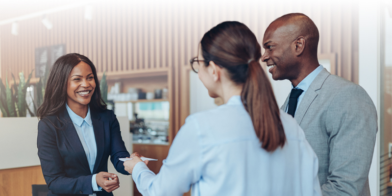 Strategies to Increase Hotel Revenue - Sabre Hospitality - Image of couple checking into hotel.